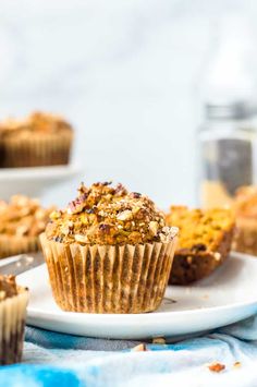 a muffin on a white plate with other muffins in the back ground