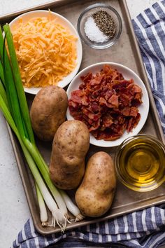 potatoes, cheese and other ingredients on a tray