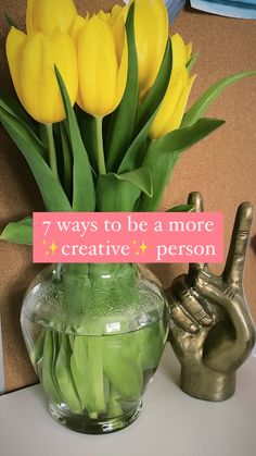 there is a vase with yellow flowers in it and a sign that says 7 ways to be a more creative person