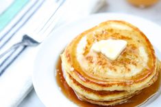 pancakes with butter and syrup on a white plate