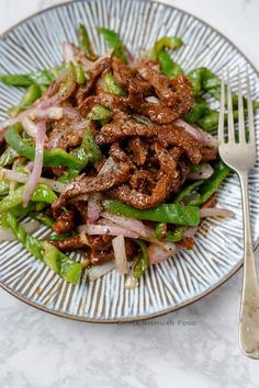 a close up of a plate of food with meat and veggies on it