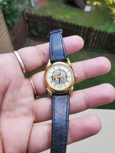 This is a vintage watch in good vintage condition. The watch will need a new battery, so I am unable to test it. For that reason, this item is being sold as is and untested. There are no major cracks, but there is wear, including scratches, color loss,  and heavy damage to the band itself. Please see photos for condition and zoom in if necessary. Vintage Skeleton Dial Watch Accessories As A Gift, Timeless Collectible Watches With Skeleton Dial, Classic Skeleton Dial Watch Accessories, Antique Gold Watch With Skeleton Dial, Vintage Brown Watch With Skeleton Dial, Skeleton Watches, Skeleton Watch, Mechanical Watch, Wrist Watches