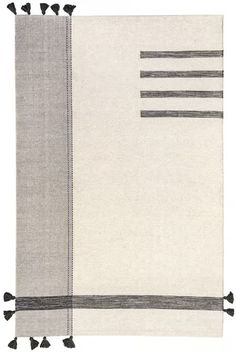 a gray and white rug with tassels on it