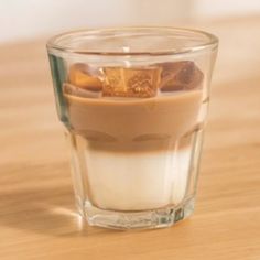 a shot glass filled with liquid and ice cubes