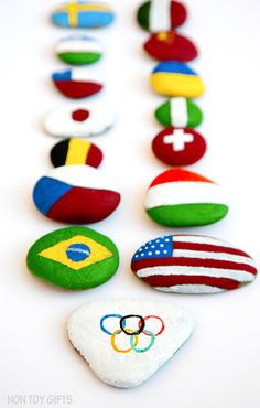 the olympic badges are made out of felt and painted to look like stones with flags on them