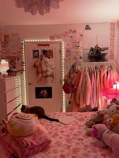 a bedroom with stuffed animals on the bed