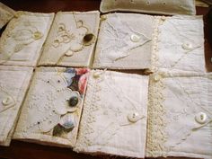 several pieces of cloth with buttons and lace on them sitting on a wooden table top