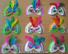 a group of colorful masks sitting on top of a wooden table