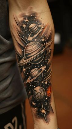 an arm tattoo with saturn and stars on it