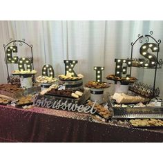 a table topped with lots of food next to a sign that says love spelled out