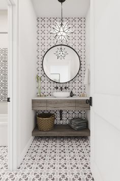 a bathroom with a sink, mirror and tiled flooring in black and white colors