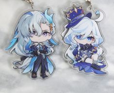 two keychains with anime characters on them, one is blue and the other is white