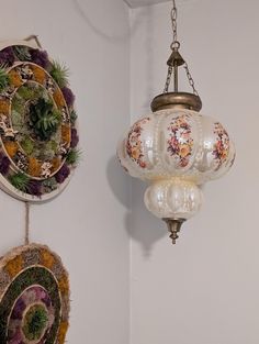 two lamps hanging on the wall next to each other