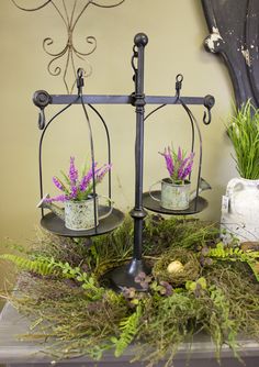 two planters with flowers in them on a table