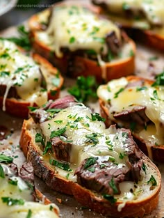 several pieces of bread topped with cheese and meat