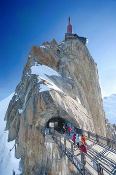 some people are walking up to the top of a mountain