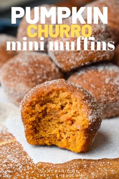 pumpkin churro mini muffins are stacked on top of each other with powdered sugar