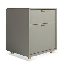 a grey cabinet with two drawers and gold handles on the bottom, against a white background