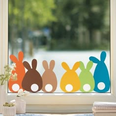 an image of four bunnies on the window sill