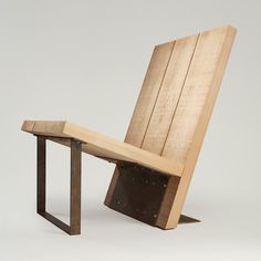 a wooden chair sitting on top of a metal frame next to a piece of wood