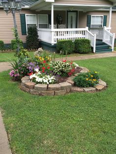 a flower bed in front of a house