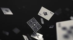 playing cards are falling from the ceiling in this black and white photo, which appears to have been altered