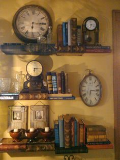 there are many books and clocks on the shelves