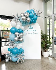 the balloon arch is decorated with silver and blue balloons