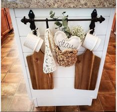 kitchen utensils hanging on the wall above an oven