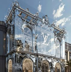 the front facade of a building with an ornate design on it's glass wall