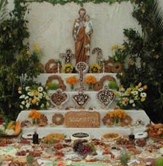 a table topped with lots of food next to a statue