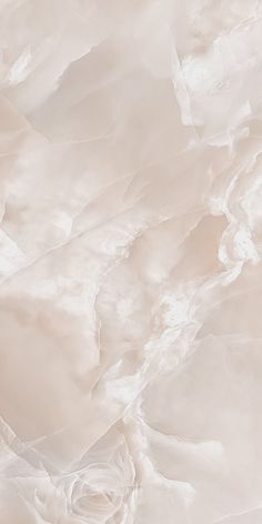 an aerial view of white and beige marbled paper, with some light colored layers