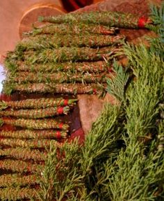 several bundles of christmas greenery sitting on top of a table