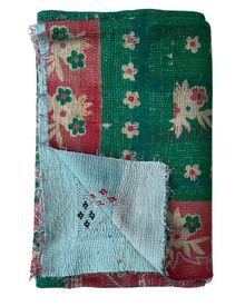 a green and red blanket with flowers on it