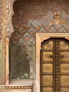 an ornately decorated door in the middle of a building