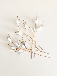 Elevate your bridal look with our Kyoto Hair Pins set. Delicately designed with a touch of gold accents, these three pins add a whimsical touch to any hairstyle. Perfect for updos, half-up styles, or down hair style. Each pin is unique, creating an artful, ethereal look for your special day. Details: Set of three bridal hair pins Flower Color: Off-white, with gold center accents Hair pin color: Gold Dimensions: Largest Pin (flower elements only): approximately 2.75 x 1.75 inches Smallest Pin (fl Jay Kay, Flower Elements, Small Pin, Bridal Look, Bridal Hair Pins, Touch Of Gold, Fantasy Inspiration, Hair Pin, Off White Color