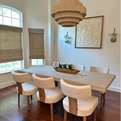 a dining room table with chairs and a bowl on it