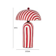 a red and white striped lamp sitting on top of a table