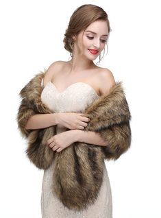 a woman in a white dress is holding a fur shawl and posing for the camera