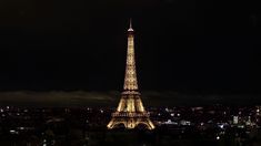 the eiffel tower is lit up at night