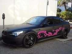 a black car parked in front of a parking meter