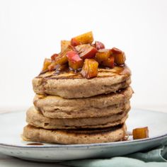 a stack of pancakes with fruit on top