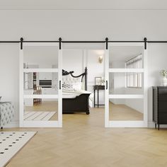 an open living room with sliding glass doors leading to the bedroom and dining room area