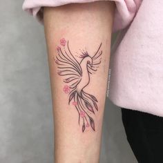 a woman with a bird tattoo on her arm