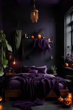 a bedroom decorated in dark colors with candles and pumpkins