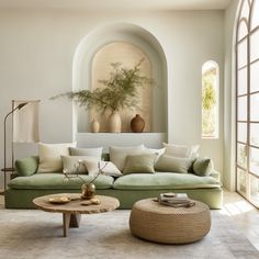 a living room filled with lots of furniture next to a wall mounted vase and potted plant