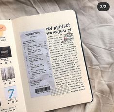 an open book with stickers on it sitting on top of a white bed sheet