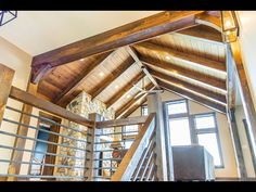 the inside of a house with wood and metal railings, stone walls and ceiling