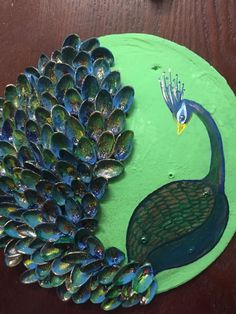 a peacock is sitting on top of a green plate