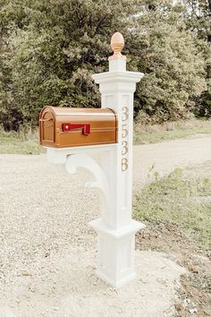 a white post with a mailbox attached to it